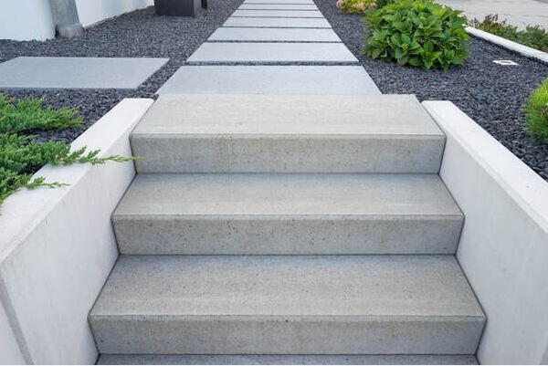 Modern Grey Concrete Steps Leading to Concrete Slab Walkway
